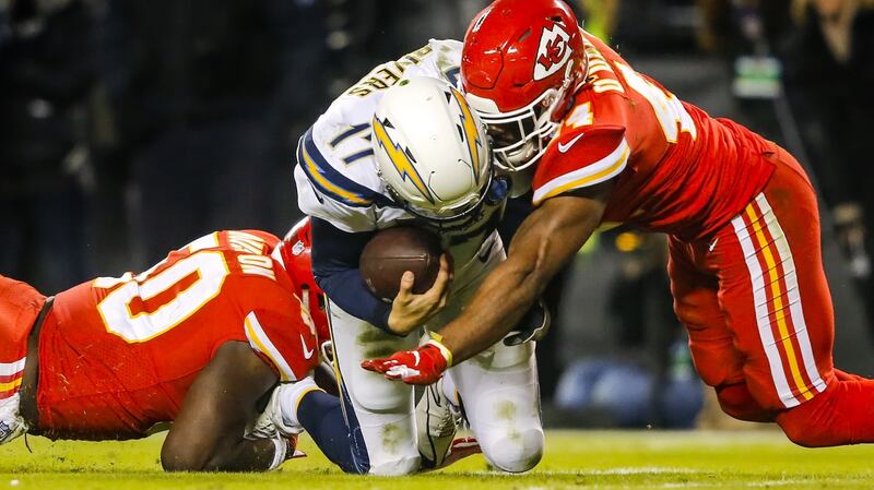 Linebacker Dorian O’Daniel of the Kansas City Chiefs tackles quarterback Philip Rivers of the Los Angeles Chargers with helmet contact. Photo: David Eulitt/Getty Images