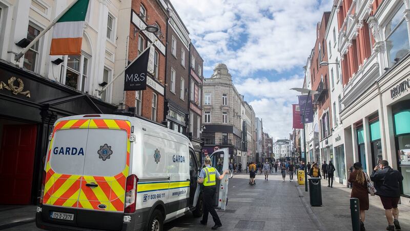 A  Garda vehicle on Grafton street in Dublin’s city centre on Sunday evening. Fourteen people were arrested that night as street disorder continued for a third evening. Photograph: Brian Lawless/PA Wire