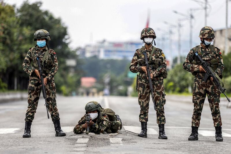 Army personnel stand guard along a street during a curfew imposed to restore law and order in Kathmandu on Thursday. Photograph: Prabin Ranabhat/AFP via Getty Images 