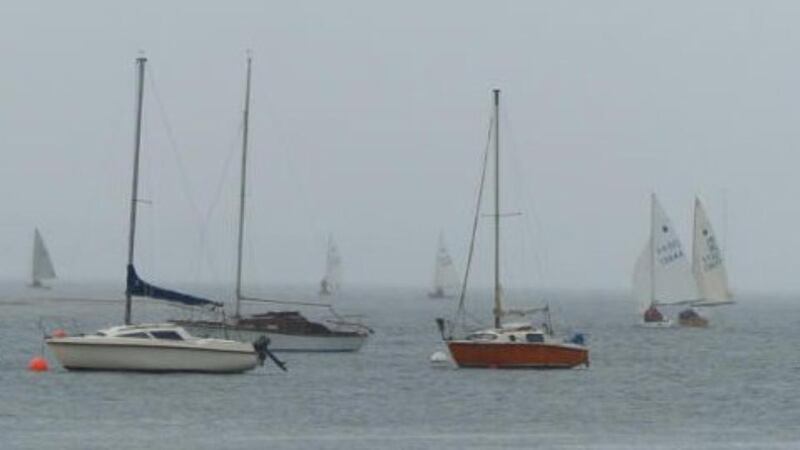 Contestants in the GP 14 World Championships can be seen in the background during a practice run yesterday.