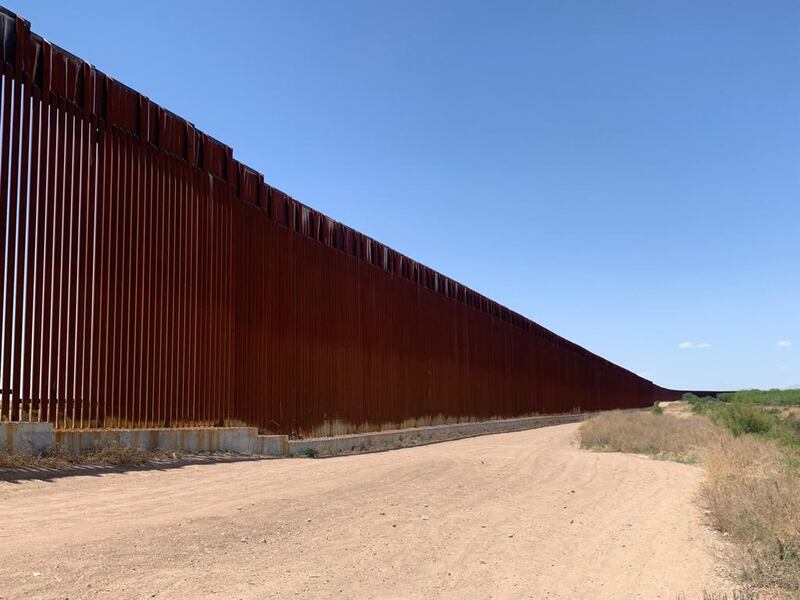 The fence stretching into the distance.