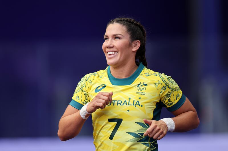 Charlotte Caslick of Team Australia smiling at a Sevens match It's no laughing matter if Australian athletes fail to deliver. Photograph:  Hannah Peters/Getty Images