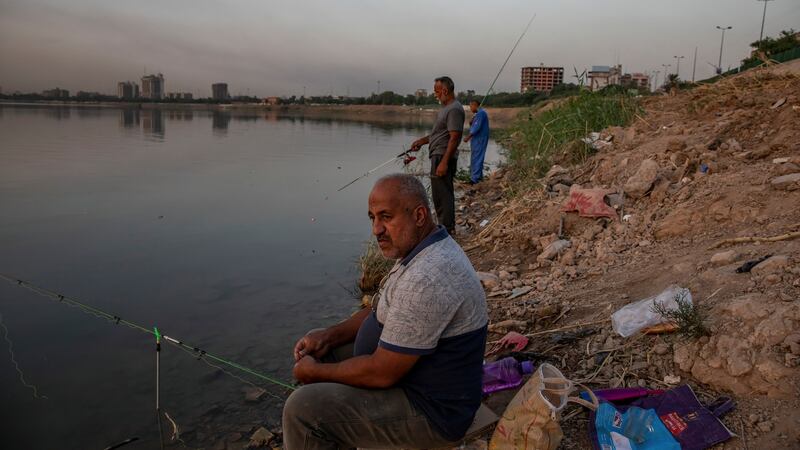 Fishing on the banks of the Tigris river in Baghdad. Iraqis vote on Sunday in parliamentary elections called a year early, after huge anti-government protests. Photograph:  Andrea DiCenzo/New York Times