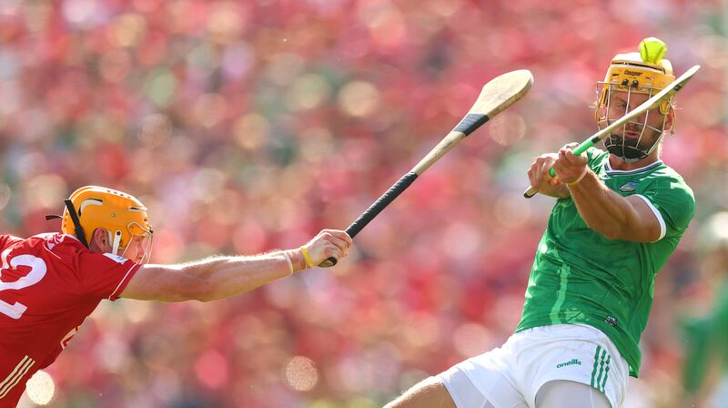 Cork’s Shane Barrett attempts a block on Limerick's Tom Morrissey. Photograph: James Crombie/Inpho