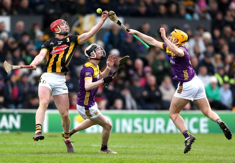 Kilkenny’s Adrian Mullen and Wexford’s Damien Reck attempt to gather the ball. Photograph: Ken Sutton/Inpho