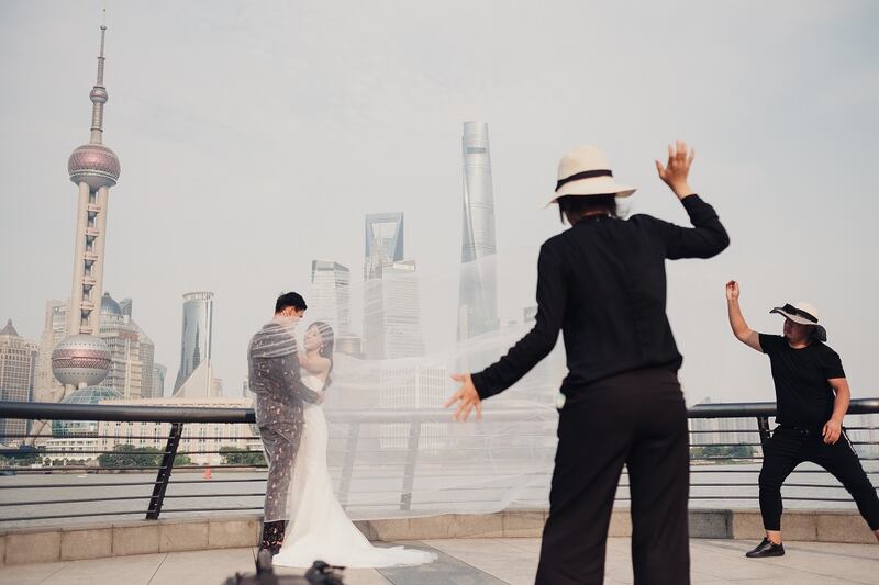 A couple posing for a wedding photographer in Shanghai in May.