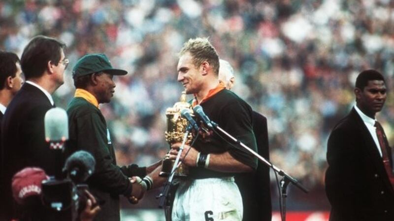 Nelson Mandela hands the Webb Ellis Cup to Springboks captain Francois Pienaar after host nation South Africa beat New Zealand to win the 1995 tournament. Photograph: Inpho