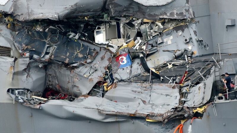 USS Fitzgerald: a sailor looks at the damaged zone of the American warship, where seven colleagues were found dead. Photograph: Franck Robichon/EPA