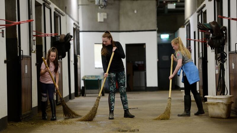 Mucking out the stables at the Cherry Orchard Equine Centre. Photograph: Alan Betson
