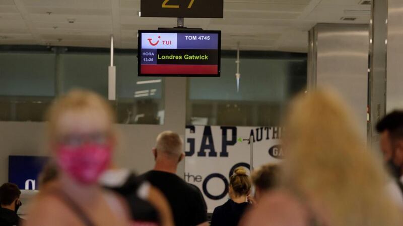 Tourists stand in two long queues to check in before departing to London at Tenerife Sur International Airport, in Granadilla de Abona, Tenerife Island on Sunday. Photograph: Ramon de la Rocha/EPA
