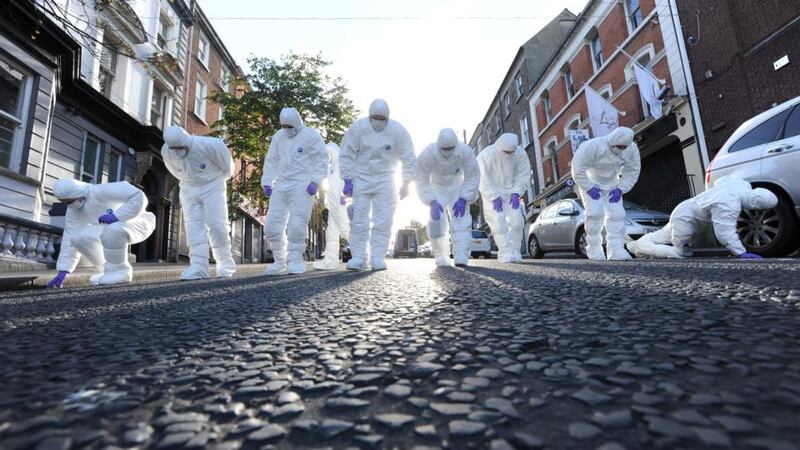 PSNI forensic officers in Shipquay Street, Derry yesterday where 	a man was shot dead in an apartment in the city centre. Photograph: Stephen Davison