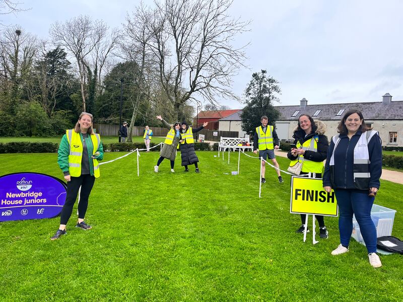 Volunteers at Newbridge House junior parkrun in Donabate, Dublin await the arrival of the runners at the finish line. 