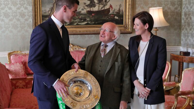 Johnny Sexton and his wife Laura  pictured with President Michael D Higgins and the Triple Crown trophy. Photograph:  Colin Keegan