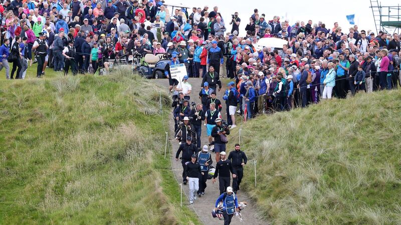 Crowds follow the group of  Rory McIlroy,   Jon Rahm and Hideki Matsuyama during day one of the Dubai Duty Free Irish Open at Portstewart. Photograph:  Niall Carson/PA Wire.