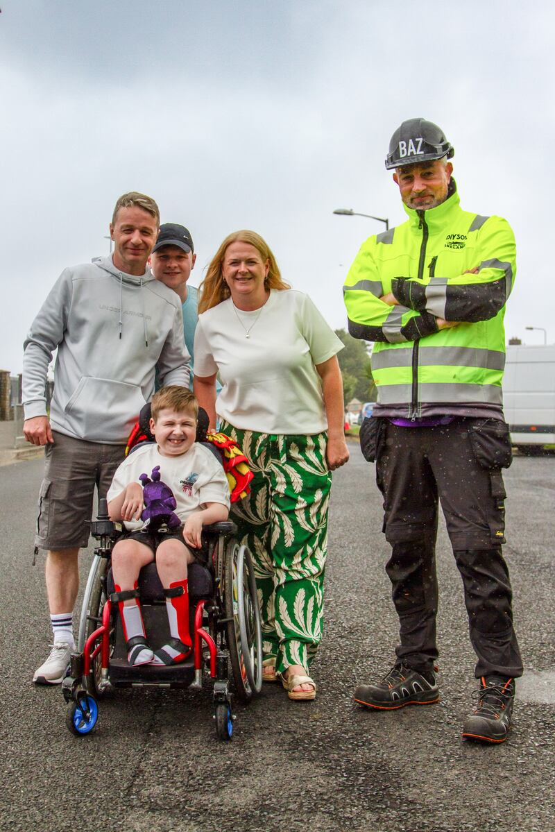 Cayden (9) with mother Sinéad, father Donald, brother Ethan (15) and presenter Baz Ashmawy at home in Tallaght. Photograph: RTÉ