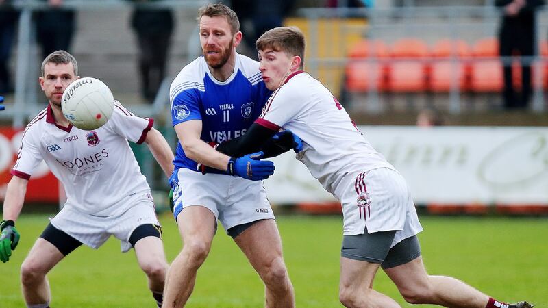 Slaughtnei’s Paul McNeill is touch tight on Cavan Gaels’ Michael Lyng. Photograph: Jonathan Porter/Inpho