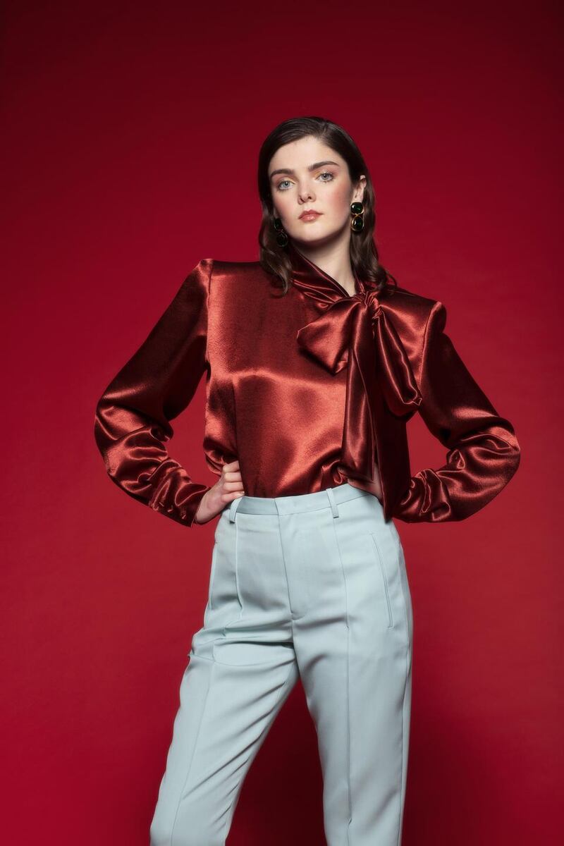 Emerald earrings, €162, Kenneth Jay Lane, Brown Thomas; bronze satin tie blouse, €619, Francoise, Emporium Kalu; teal trousers, €490, Isabel Marant, Costume