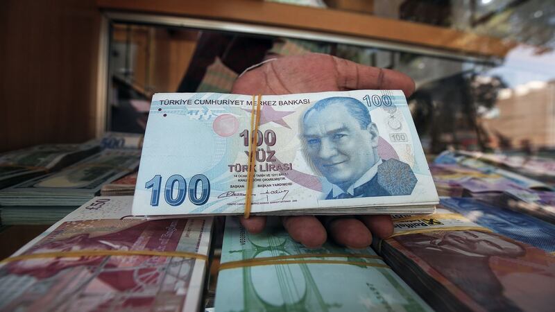 A wad of one-hundred Turkish lira notes: the currency has lost 45 per cent of its value against the dollar this year. Photograph: Yasser Al-Zayyat
