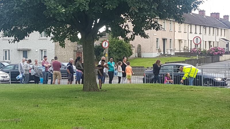 People queuing at a “temporary water station” on Bóthar Brugha, Drogheda. Photograph: Patrick Logue