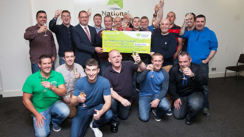 Soldiers from the 3rd Infantry Battalion in Stephens Barracks Kilkenny who netted  €452,700 in the lottery celebrate their good luck at the National Lottery office in Dublin. Photograph: Gareth Chaney Collins