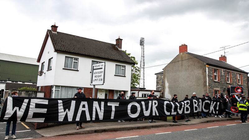 Protestors hold up a banner outside the ground. Photo: Tommy Dickson/Inpho