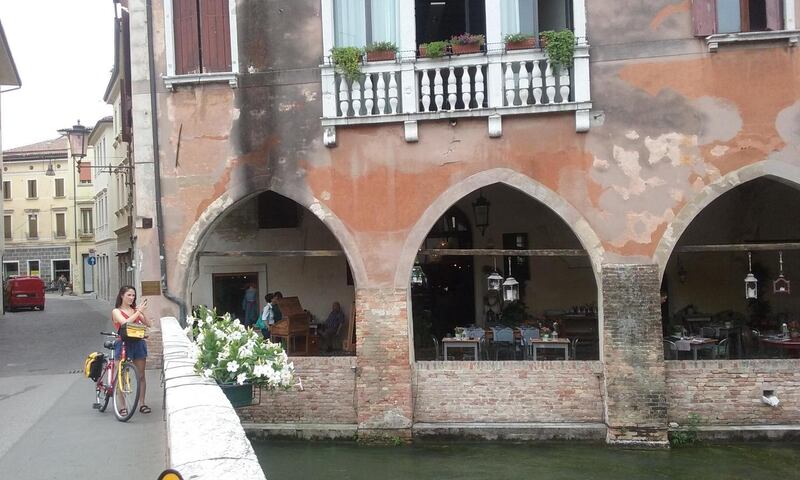 Clare Harrington gets off her  bike to admire the view of the  water in Treviso. Photograph:  Emma Cullinan