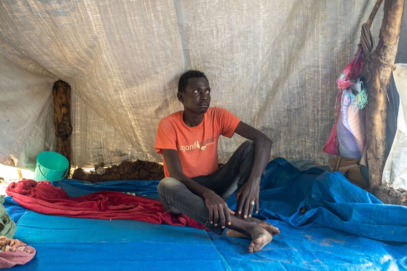 Bahaadin Adam at a transit camp in Renk, South Sudan, after fleeing fighting in Darfur. Most of his family had managed to escape Nyala, but his two younger sisters were killed by artillery fire. Photograph: Joao Silva/New York Times
                      