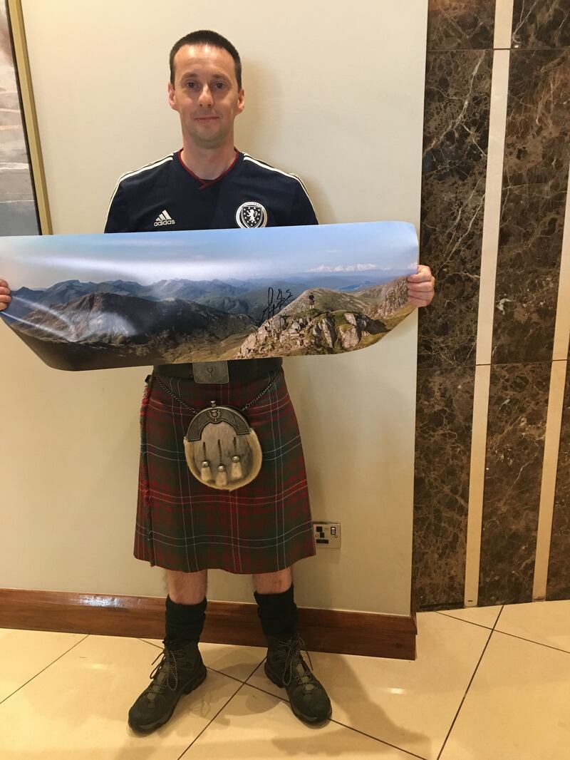 Paul Wilson with his poster. Photograph: Stephen Farrell