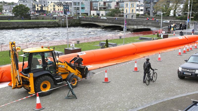 Galway City Council staff install a section of an aquadam near the Spanish Arch beside the River Corrib on Wednesday. Photograph: Joe O’Shaughnessy.