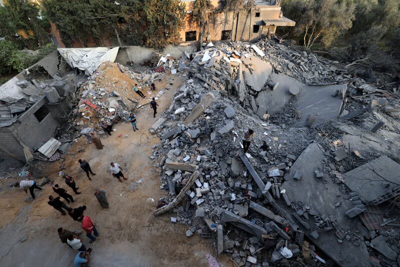 People inspect the damage to a building after Israeli strikes in the Rafah camp on the southern Gaza Strip on Saturday. Photograph: Mohammed Abed/AFP via Getty Images