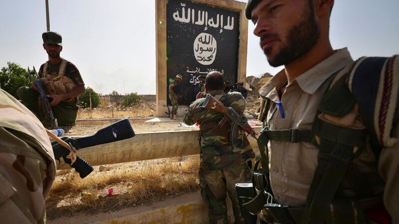 Shi\ Popular Mobilisation Forces next to the black flag sign commonly used by Islamic State militants, after liberating the city Hawija, Iraq, on October 5th. Photograph: Reuters