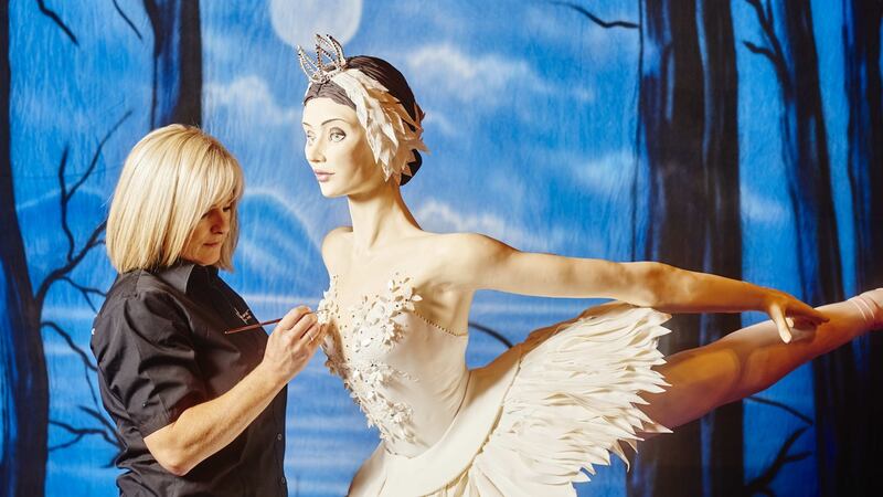 Emma Jayne putting the finishing touches to her  Swan Lake exhibit at Cake International