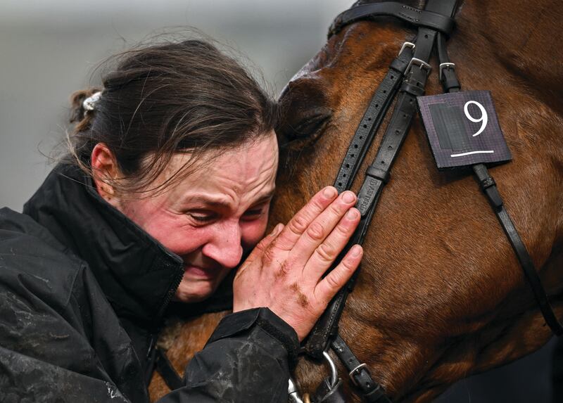 JOY: Groom Emilie Seigle and ‘Absurde’ share an emotional moment of joy after the horse won the BetMGM County Handicap Hurdle on day four of the Cheltenham Racing Festival at Prestbury Park in Cheltenham, England. Photograph: David Fitzgerald / Sportsfile
