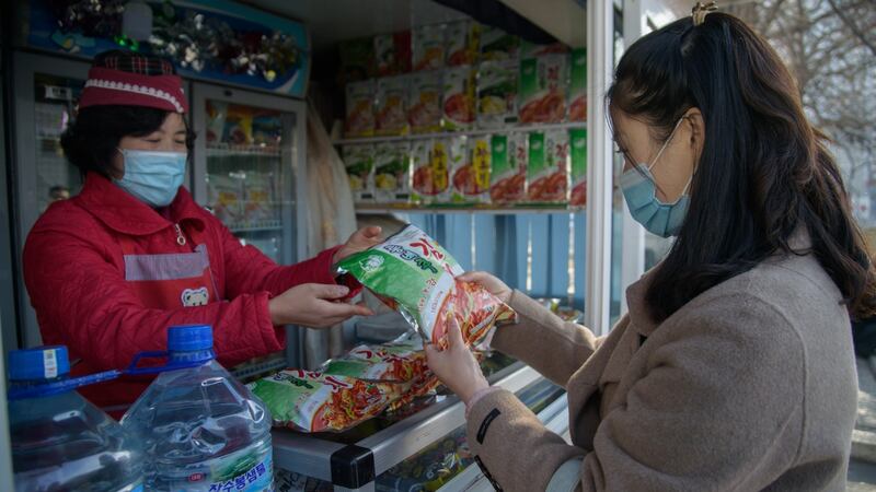 A woman buys kimchi at a fool stall in Pyongyang. Photograph: Kim Won-jin/AFP via Getty Images