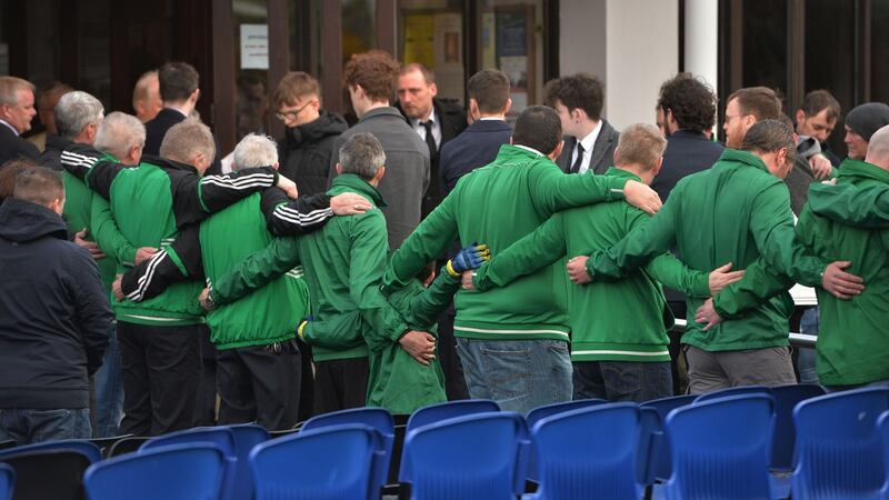 Members of the Rathcoole Football Club form a guard of honour at the funeral Mass for  Conor, Darragh and Carla McGinley in the Church of The Holy Family, Rathcoole on Friday. Photograph: Alan Betson/The Irish Times