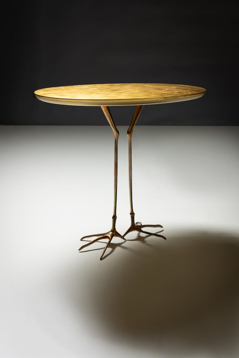 the surrealist Traccia table by German-born  Swiss artist and photographer, Méret Oppenheim.   The gold leaf top has birds feet imprints on it to complement the brass sculpted birds legs base (€2,000-€3,000).