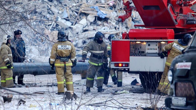 Emergency  employees work at the scene of a collapsed apartment building in Magnitogorsk, a city of 400,000 people, about 1,600 kilometers  southeast of Moscow. Photograph:  AP