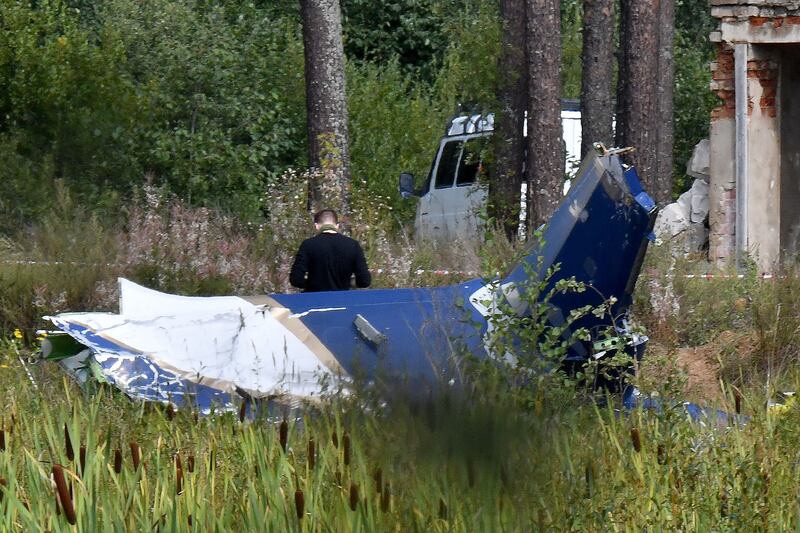 A law enforcement officer  at the site of a plane crash near the village of Kuzhenkino, Tver region. Russian state-run news agencies  said that Yevgeny Prigozhin, was on the list of passengers. All 10 people on board died. Photograph: Olga Maltsevao/AFP via Getty Images