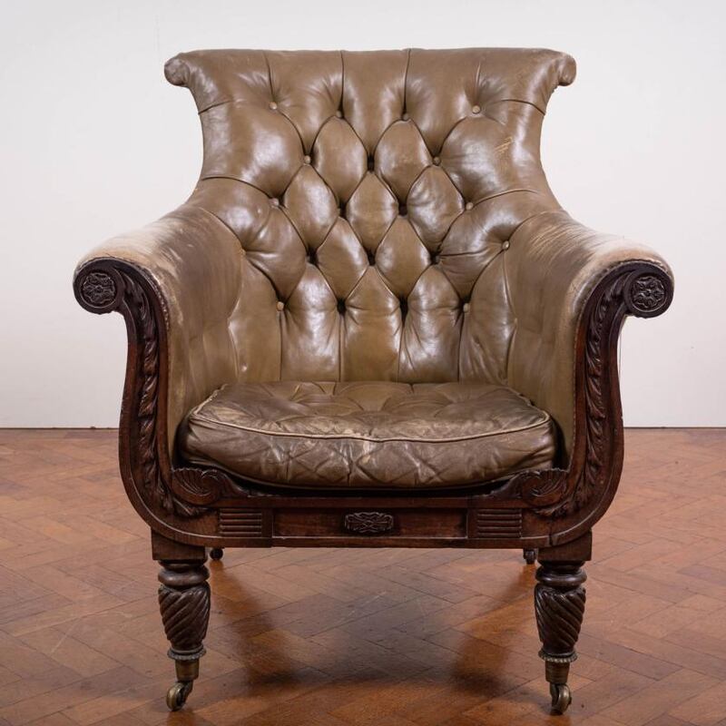 A Regency green leather and brass studded library chair is part of The David Cahill Collection being sold by  de Vere’s (€2,000-€3,000)