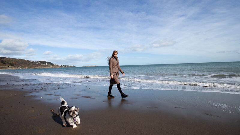 Priska Haefliger walks Freddie the dog on the sand on Killiney beach. Photograph: Tom Honan