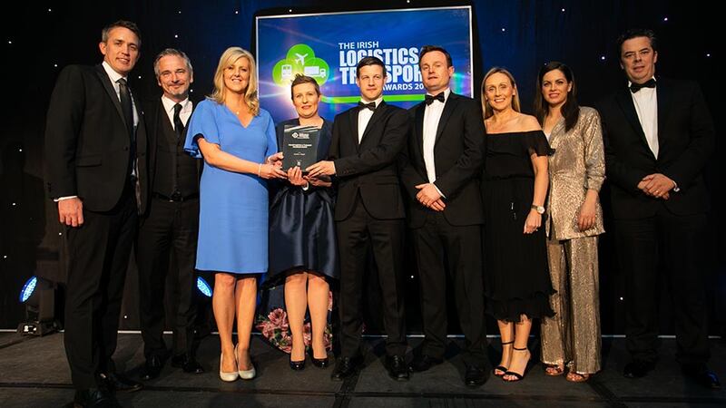 Conor Morgan, Head of Transport & Logistics, AIB Corporate Banking presents the Overall Logistics & Transport Excellence Award to the Kuehne + Nagel team.