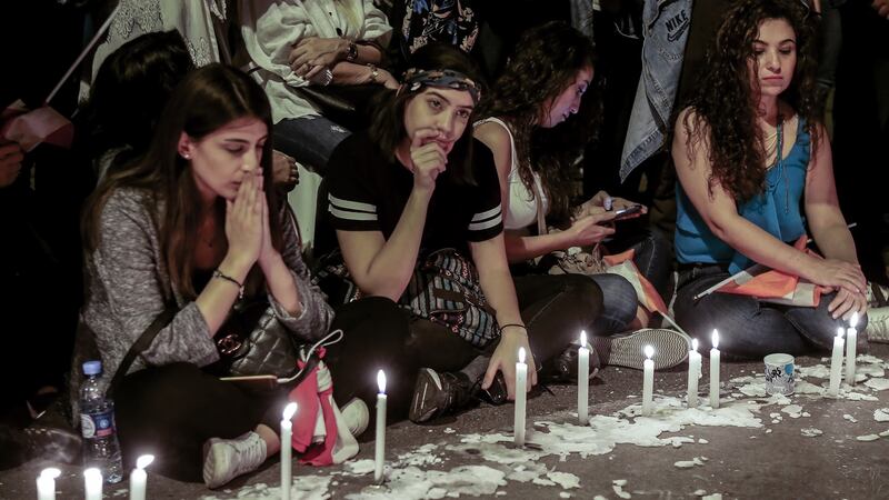 Protesters lit candles and carry pictures of anti-government activist Alaa Abu Fakher during a vigil in Martyrs’ Square, Beirut. Photograph: Nabil Mounzer/EPA
