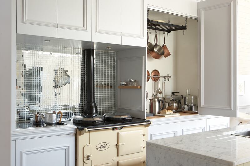 Appliance larder in Sandycove, Co Dublin home designed by interior architect Gillian Sherrard. Mirrored splashback adds interest and individuality