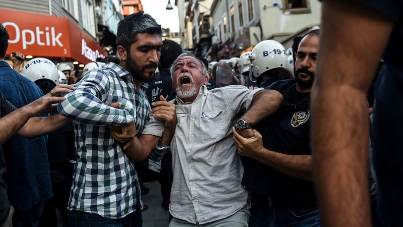 Turkish police officers arrest protesters, gathered in support of workers that were arrested earlier for protesting over labour conditions at Istanbul’s new airport, in the city. Photograph: Bulent Kilic/AFP/Getty Images