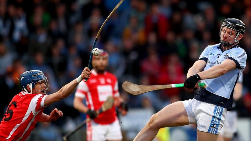 Cuala’s Sean Moran blocks a shot from Kevin Downes of Na Piarsaigh at Portlaoise. Photograph: James Crombie/Inpho