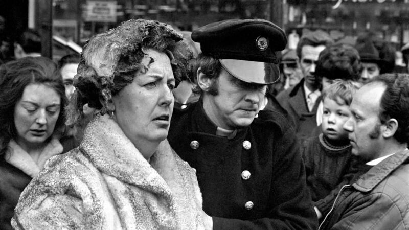 A fireman escorts a victim from the scene. Photograph: Getty
