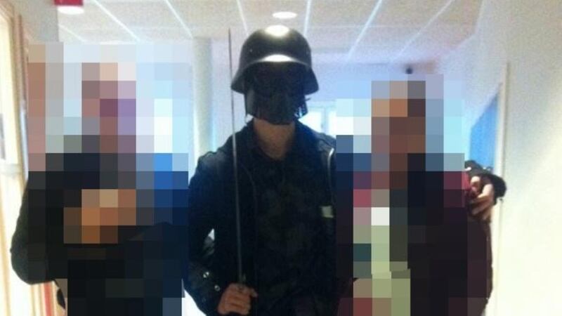 A picture made available by a student shows the masked man armed with a sword posing for a photo with two other students before attacking students and staff at the primary and middle school in Trollhattan, southwestern Sweden. Photograph: AFP/Getty Images