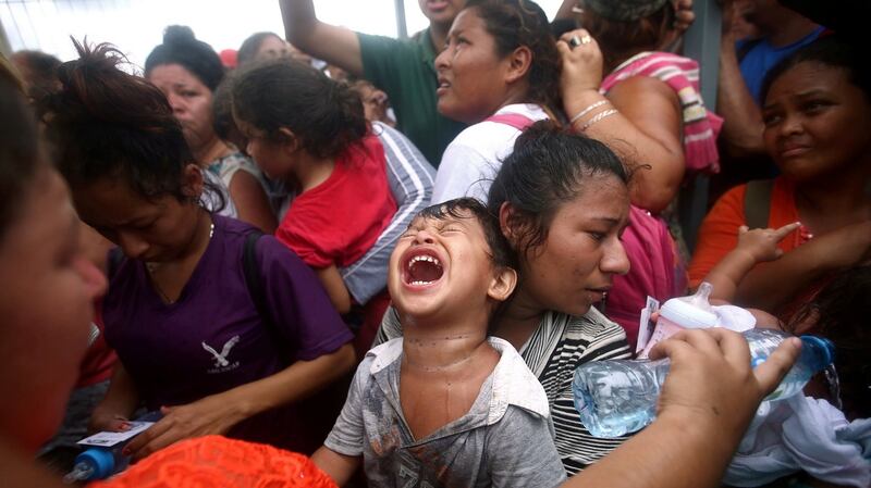 A  Central American child, part of a caravan trying to reach the US, as he waits to apply for asylum in Mexico. Photograph: Reuters/Edgard Garrido