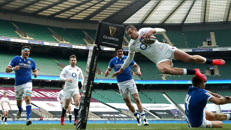 England’s Jonny May dives over Luca Sperandio of Italy to score his  side’s third try during the  Six Nations match at Twickenham. Photograph: David Rogers/Getty Images