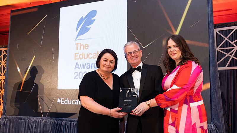 Dr Ciarán Ó Hannracháin, awards judge, presents the best library award to Michelle Breen and Ashling Hayes, University of Limerick